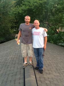 two guys standing on roof