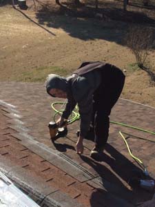 man power nailing roof shingles