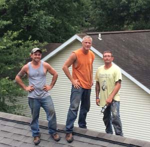 3 guys balanced on rooftop