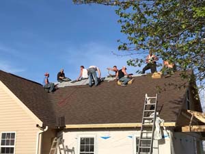 men finishing roofing job