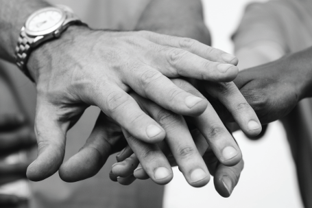 men's hands stacked unified